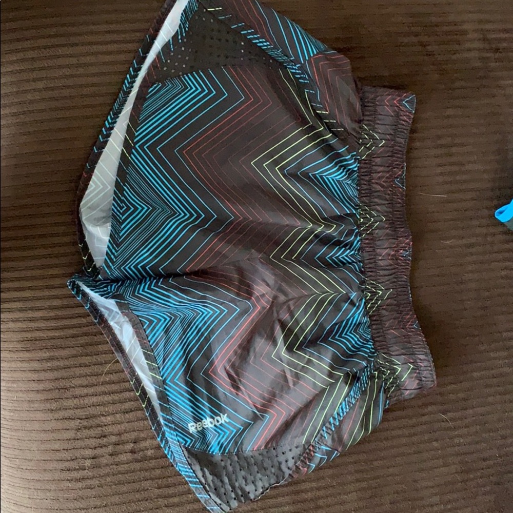 Reebok multi-colored, medium running shorts.